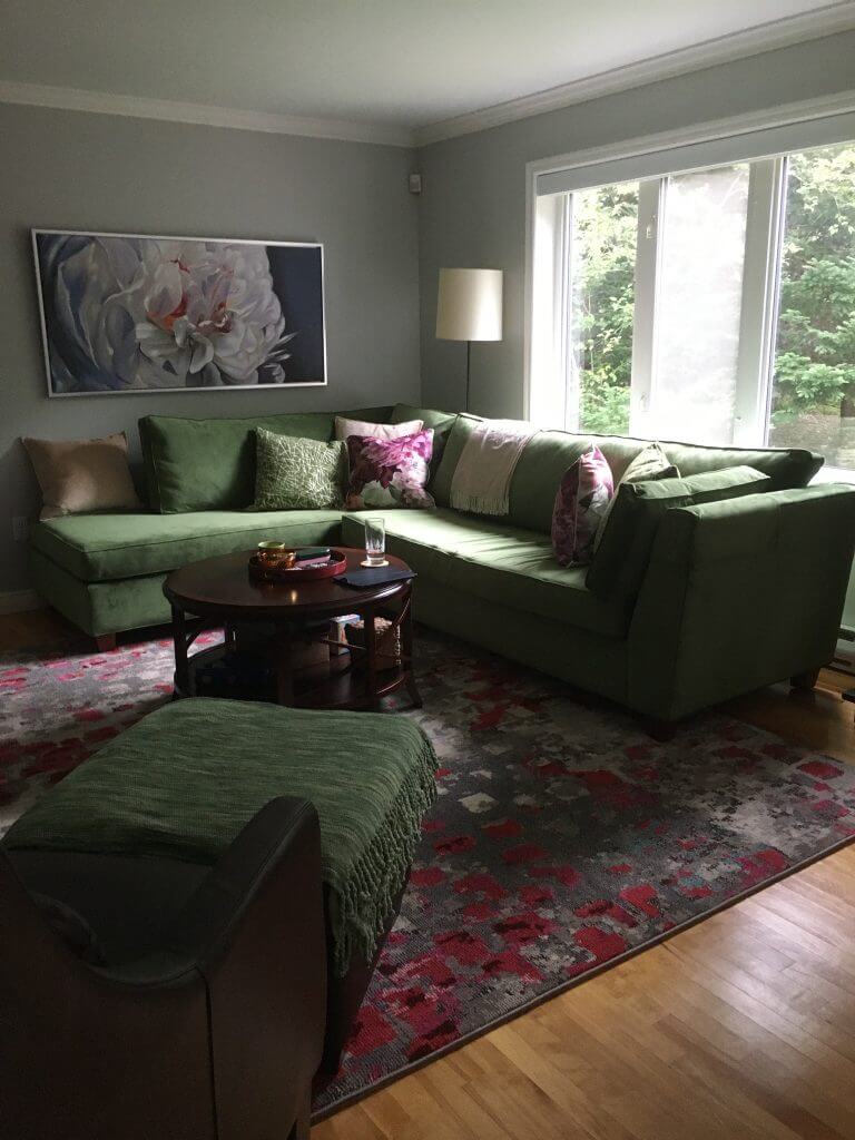 Living room with beautiful couch, painting frame, center table, and window